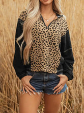 Leopard patchwork contrast stitching quarter zip hoodie with leopard print and black textured fabric, slightly stretchy material
