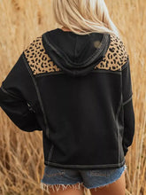 Black quarter zip hoodie with leopard-print shoulder panels, white stitching, and slightly stretchy knotted cuff detailing