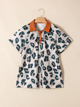 White short sleeve blouse with bold dark green and muted pink leopard print and contrasting orange collar and placket