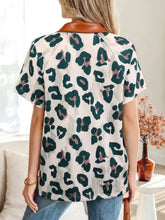 Leopard print short sleeve blouse in dark green and muted pink with an off-white background and brown contrast collar