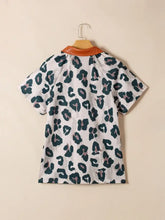 White short sleeve blouse with leopard print in dark green and muted pink featuring an orange contrast collar