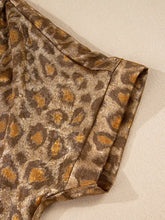 Leopard print button-down shirt made of shimmering gold and brown satin fabric featuring a subtle sheen and print button details