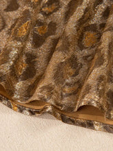 Luxurious gold and brown velvet leopard print button-down shirt with shimmering textured surface
