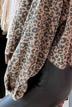 Leopard print cardigan with black leggings and white lace trim