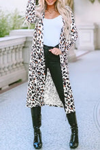 Leopard print duster coat with black and white spots, long sleeves, open front