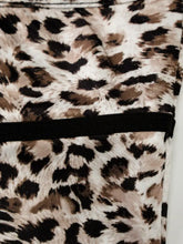 Leopard print corduroy pants with black elastic waistband styled with a leopard print lace trim cami