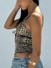 Leopard print lace trim cami featuring a leopard print crop top with thin black straps and a tied waistband