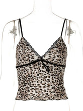 A delicate leopard print lace trim cami with soft fabric texture and thin straps in neutral tones