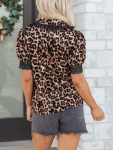Leopard print short sleeve shirt featuring black lace trim at collar and cuffs with leopard print lace detail