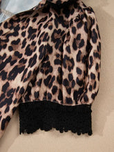 Leopard print lace short sleeve blouse with black lace trim at the cuffs for stylish casual wear