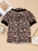 Leopard print lace trim short sleeve shirt in soft flowing fabric with black lace trim at collar and sleeves