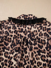 Leopard print short sleeve blouse featuring black lace trim collar in a stylish leopard print lace design