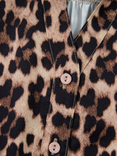Leopard print lace trim short sleeve shirt with pink buttons and contrasting stitching in leopard print lace design