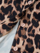 Leopard print lace short sleeve blouse with tan and black pattern and light pink buttons