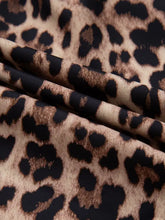 Leopard print lace trim short sleeve shirt featuring black and tan faux leather fabric with bold leopard print pattern
