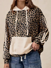 Leopard print long sleeve hoodie with matching front pocket and cream-colored drawstrings made from slightly stretchy fabric