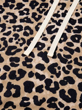 Beige and black leopard print slightly stretchy long sleeve hoodie with cream drawstrings and front pocket machine wash safe