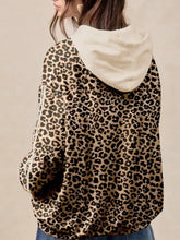 Leopard print long sleeve hoodie with slightly stretchy beige and black fabric and a soft cream-colored hood for machine wash