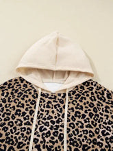 Cream-colored leopard print long sleeve hoodie with pocket made of slightly stretchy fabric and machine wash friendly