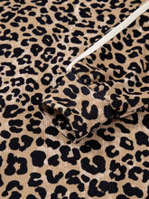 Leopard print long sleeve hoodie with pocket in tan and black corduroy featuring a ribbed texture and slightly stretchy fabric