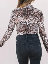 Leopard print long sleeve mock neck bodysuit in black brown and beige fitted fabric for stylish layering