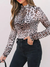 Leopard print long sleeve mock neck bodysuit in sheer black and beige fabric with a high neckline