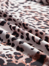Leopard print long sleeve mock neck bodysuit with soft flowing fabric in black and muted rose gold on white base