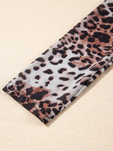 A stretchy leopard print long sleeve mock neck bodysuit in black brown and white for stylish layering