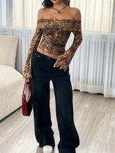 A leopard print off-shoulder long-sleeve top in bold brown and gold with stretchy, form-fitting fabric