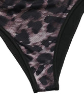 Black and mauve leopard print mesh bikini bottom with solid black trim complementing shoulder long sleeve bodysuit
