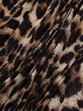 Leopard print pleated maxi skirt with brown and black spots on beige background