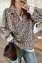Leopard print quarter-zip sweatshirt in cream corduroy with black pattern and white ribbed cuffs machine wash cold