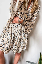Leopard print ruffled dress with bell sleeves and floral accents