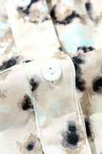 Leopard print ruffled dress with bell sleeves and floral accents