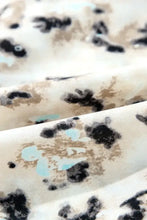 Cream leopard print plush blanket with ruffles and floral accents