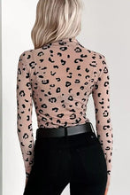 A fitted beige long-sleeved leopard print sheer mesh bodysuit crafted from stretchy fabric