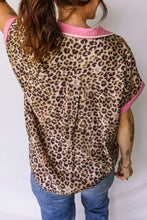 Leopard print short sleeve blouse with pink trim on collar and sleeves made of lightweight fabric