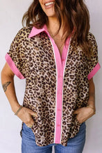 Leopard print short sleeve button-up shirt with pink collar, sleeve cuffs, and contrasting pink placket