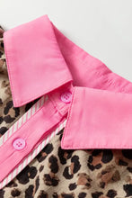 Pink button-up collar with matching buttons layered over leopard print short sleeve fabric in leopard print short shirt