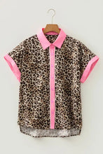 Leopard print short sleeve blouse with vibrant pink collar cuffs and button placket for stylish wear
