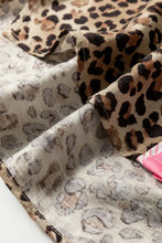 Leopard print short sleeve shirt made of soft lightweight fabric with bold tan and black leopard print pattern