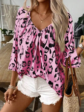 Pink leopard print v neck blouse with three quarter sleeves and ruffled neckline for stylish casual wear
