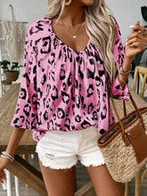 Pink leopard print v neck blouse with loose flowing fit and three quarter sleeves in lightweight fabric