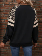 Black sweatshirt with leopard raglan sleeve striped cream-colored stripes machine wash cold fabric detail