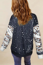 Women’s black leopard round neck long sleeve sweatshirt with white paint splatters