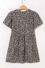 Gray leopard print denim dress with round neck puff sleeves and tiered skirt on wooden hanger