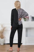 Black and leopard-print two-piece loungewear set with long sleeve round neck top and drawstring pants