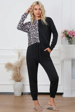 Black and white leopard print long-sleeved top with black drawstring joggers lounge set featuring sleeve length detail