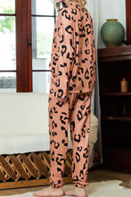 A peach-colored leopard round neck top and drawstring pants lounge set with long sleeve length and loose-fitting pants