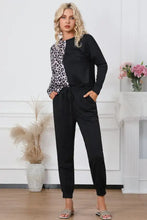 Black and white leopard print round neck top with long sleeve length paired with black drawstring joggers lounge set